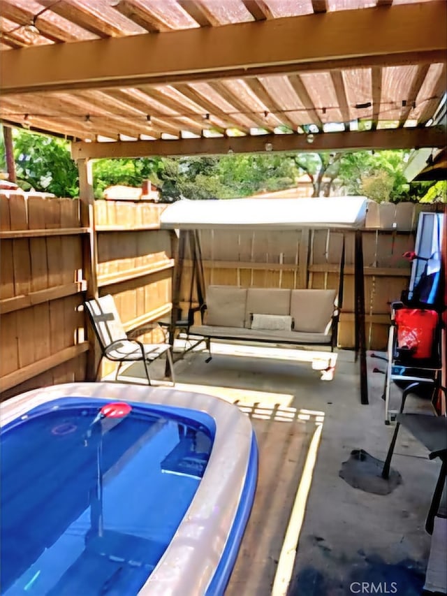 view of swimming pool with a pergola