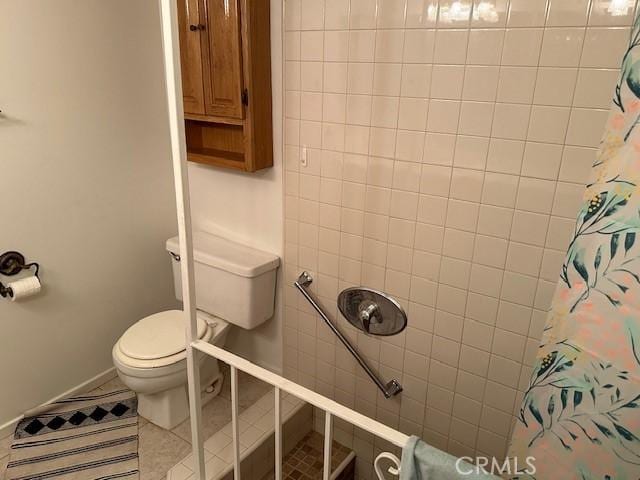 bathroom featuring a shower with shower curtain, toilet, and tile patterned floors