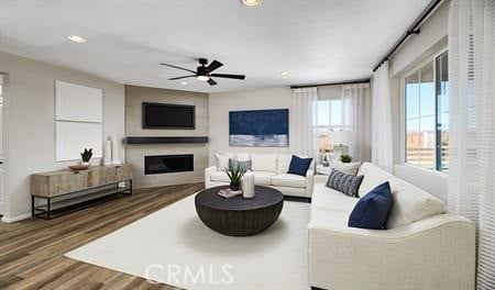 living room featuring ceiling fan and dark hardwood / wood-style flooring