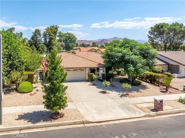 view of front of property with a mountain view and a garage