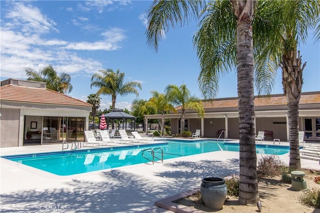 view of pool featuring a gazebo and a patio