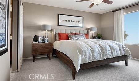 bedroom featuring ceiling fan, light colored carpet, and multiple windows