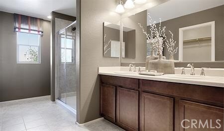23826 Moonrise Ct, Corona, CA 92883 - full bath featuring double vanity, a shower stall, tile patterned floors, and baseboards