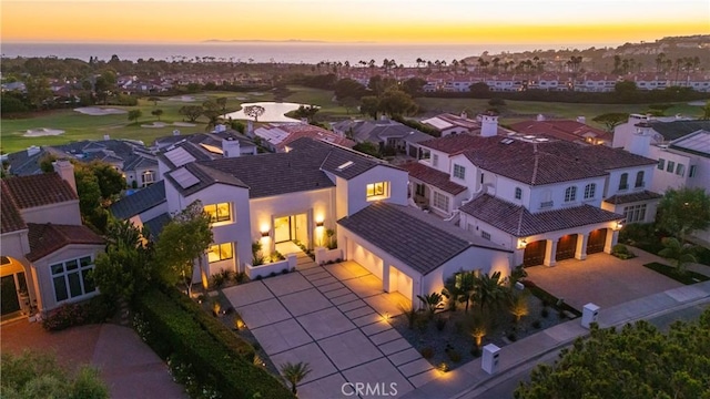 aerial view at dusk with a water view