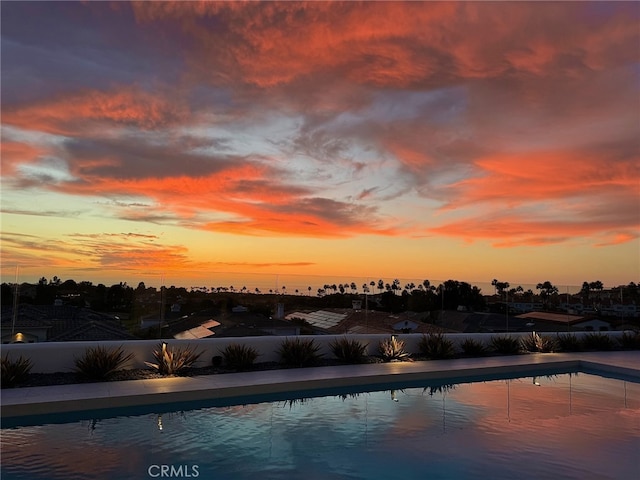 view of pool at dusk