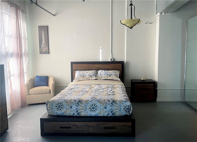 bedroom featuring concrete floors