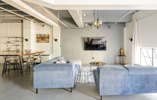 living room with beam ceiling and concrete flooring