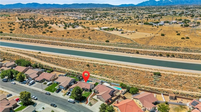 birds eye view of property with a mountain view