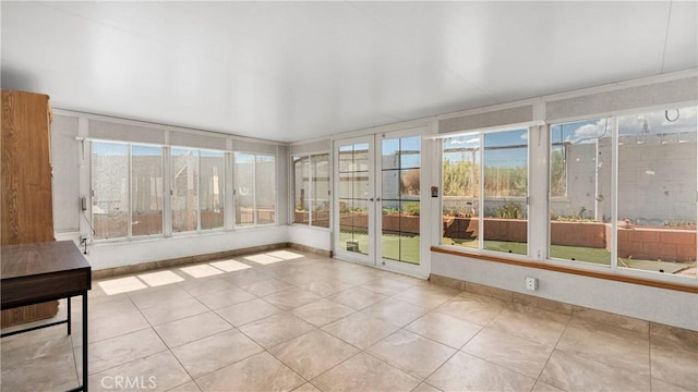 unfurnished sunroom featuring plenty of natural light and tile patterned flooring