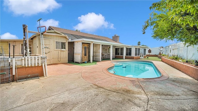 view of swimming pool with a fenced backyard, a sunroom, a patio, and a fenced in pool