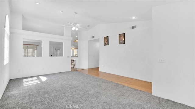 spare room featuring visible vents, recessed lighting, high vaulted ceiling, a ceiling fan, and carpet floors