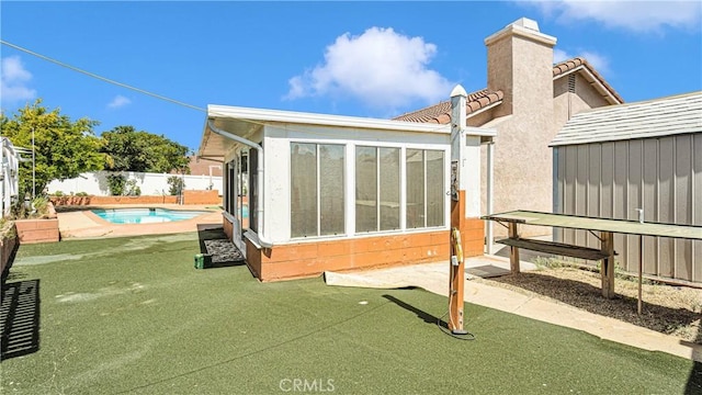 exterior space featuring a fenced in pool, a fenced backyard, and stucco siding