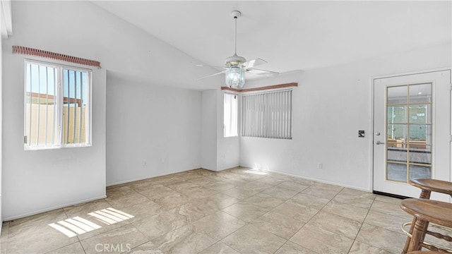 empty room featuring ceiling fan and plenty of natural light