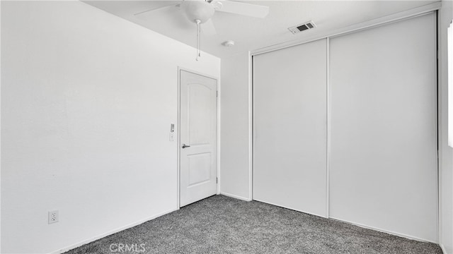 unfurnished bedroom with ceiling fan, a closet, and carpet flooring