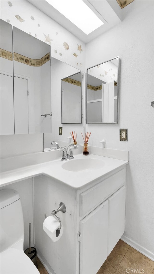 bathroom featuring vanity, toilet, and tile patterned floors