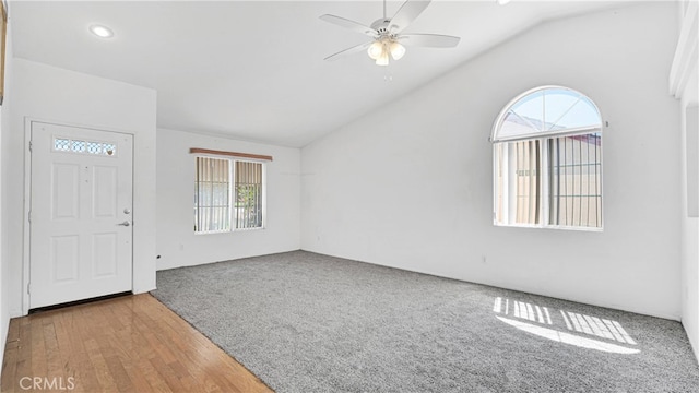 foyer with wood-type flooring, lofted ceiling, plenty of natural light, and ceiling fan