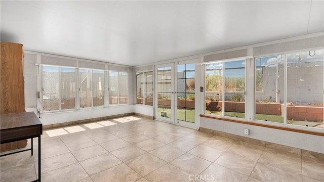 unfurnished sunroom with a wealth of natural light and tile patterned flooring