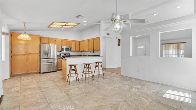 kitchen with a kitchen breakfast bar, vaulted ceiling, visible vents, appliances with stainless steel finishes, and ceiling fan