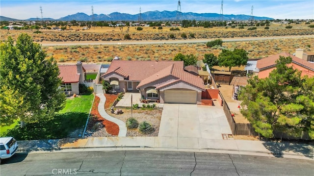 birds eye view of property featuring a mountain view