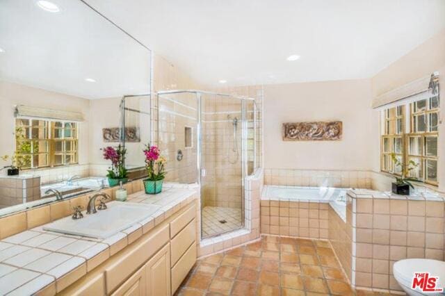 bathroom with an enclosed shower, vanity, and tile patterned floors