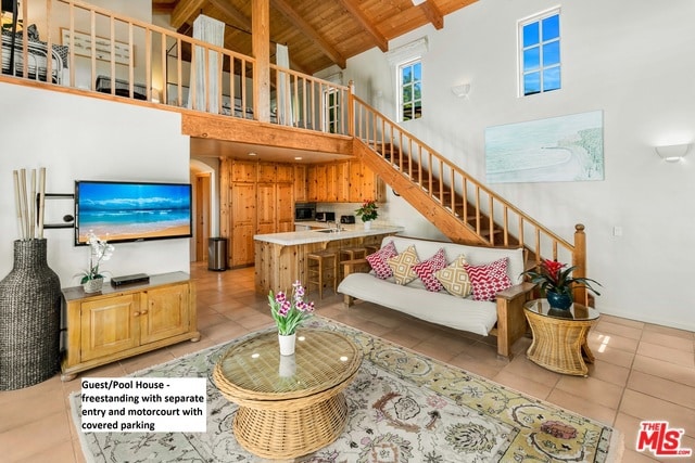 tiled living room featuring beamed ceiling, high vaulted ceiling, and wooden ceiling