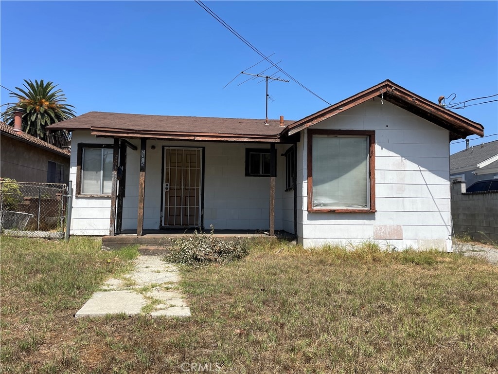 back of property featuring a lawn