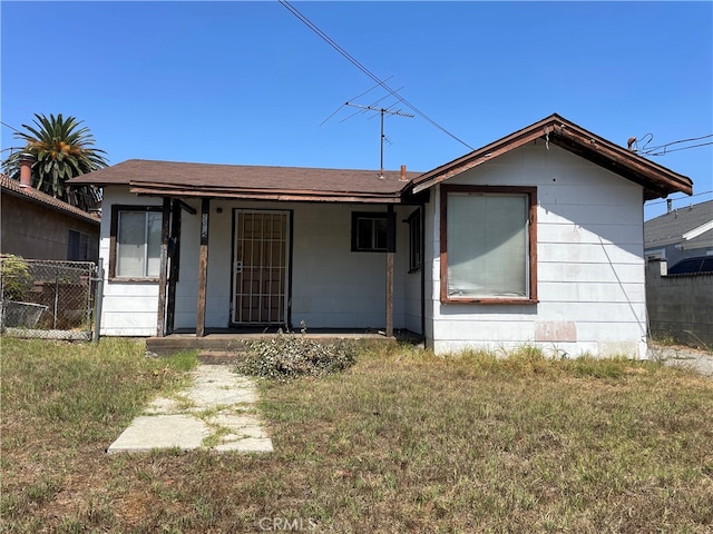 back of property featuring a lawn