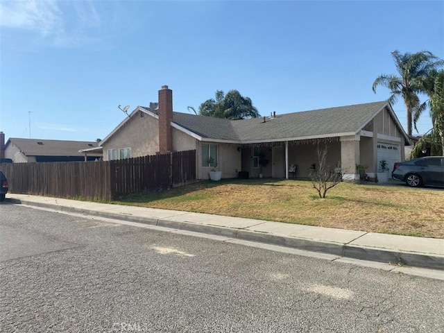 ranch-style house with a garage and a front yard