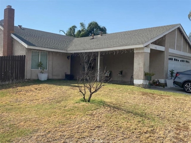 view of front facade featuring a front yard and a garage