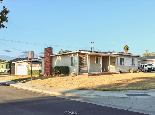 single story home featuring a front yard and a garage