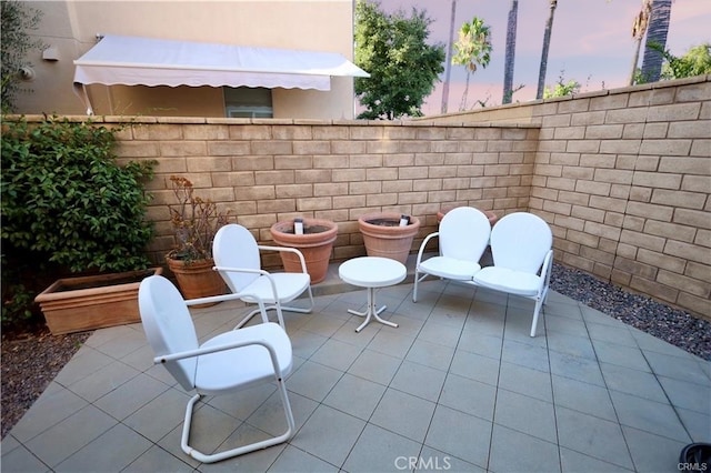 view of patio terrace at dusk