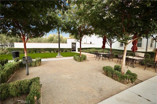 view of home's community with a lawn and a patio