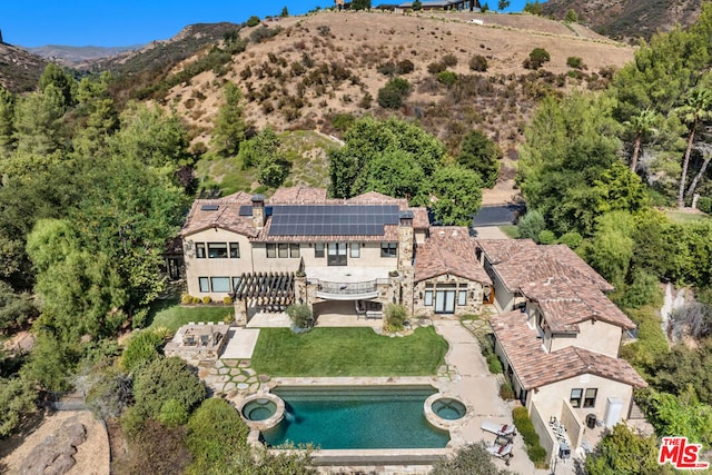 birds eye view of property featuring a mountain view