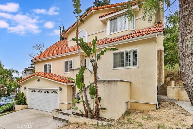 mediterranean / spanish-style home with a garage