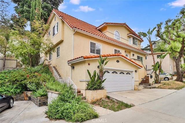 mediterranean / spanish-style house with a garage