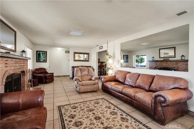 tiled living room with a brick fireplace and a textured ceiling