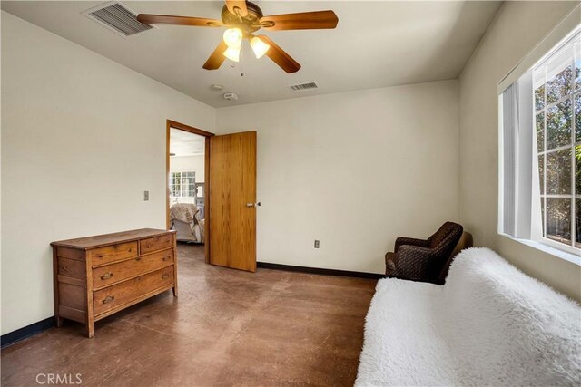 sitting room featuring a wealth of natural light and ceiling fan