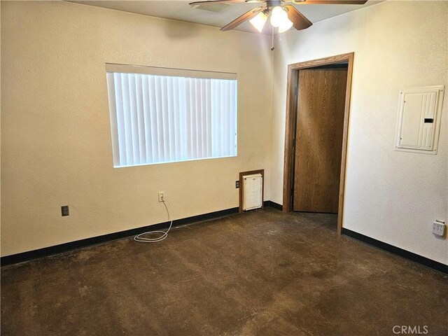 unfurnished room featuring ceiling fan and electric panel