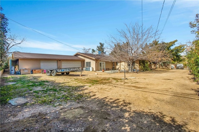 back of property featuring a garage