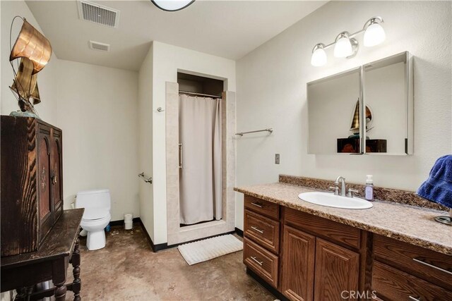 bathroom with vanity, toilet, and curtained shower