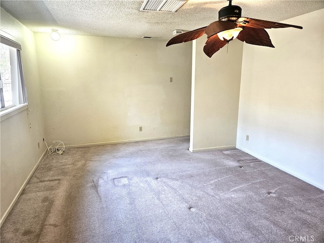 empty room featuring carpet floors, a textured ceiling, and ceiling fan