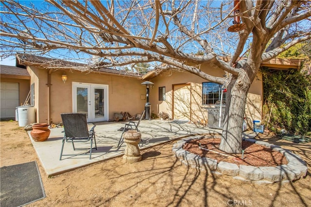 rear view of house with french doors and a patio