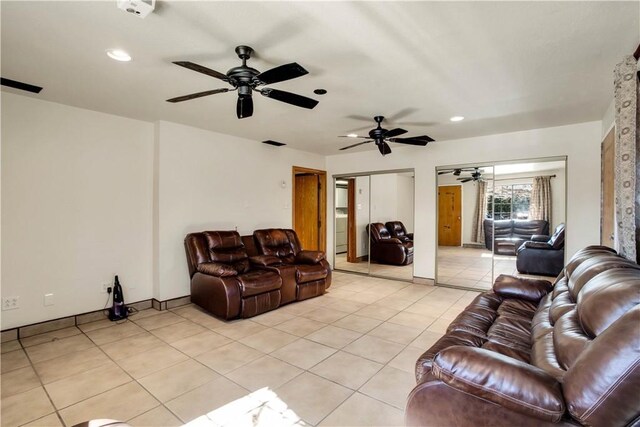 tiled living room with ceiling fan