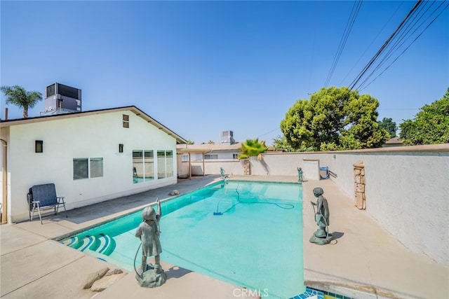 view of swimming pool with cooling unit and a patio area