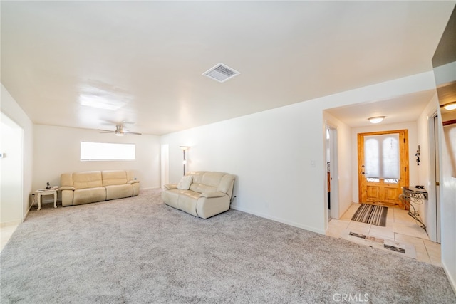 carpeted living room with ceiling fan