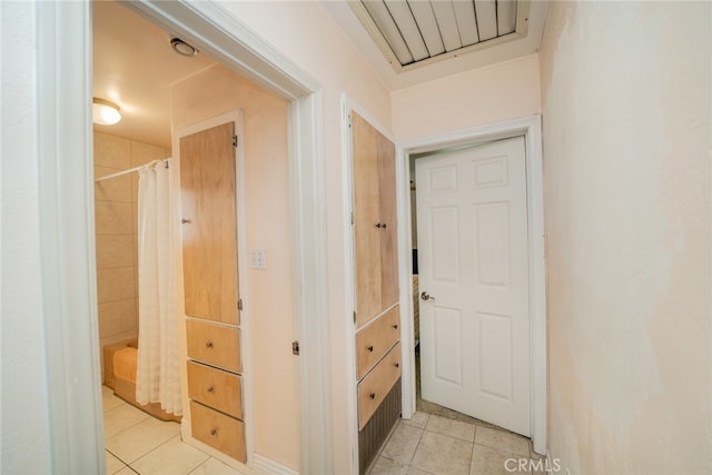 corridor featuring light tile patterned floors