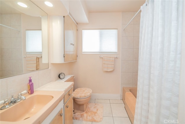 full bathroom featuring shower / bath combo with shower curtain, tasteful backsplash, vanity, toilet, and tile patterned floors