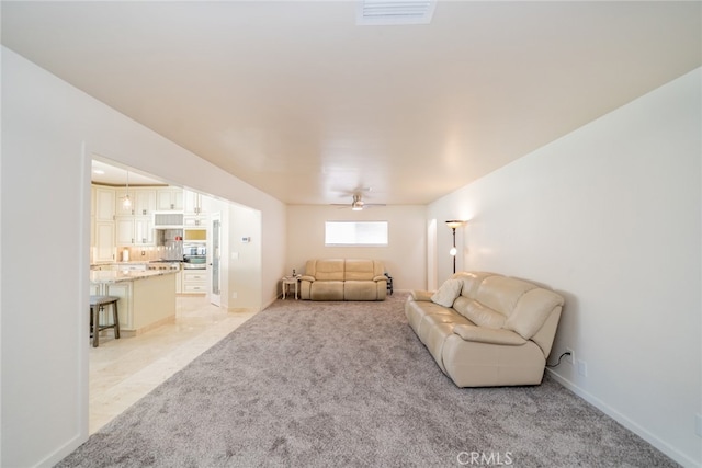 carpeted living room featuring ceiling fan