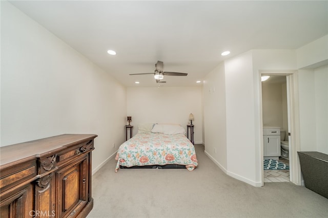 carpeted bedroom with ceiling fan and ensuite bathroom