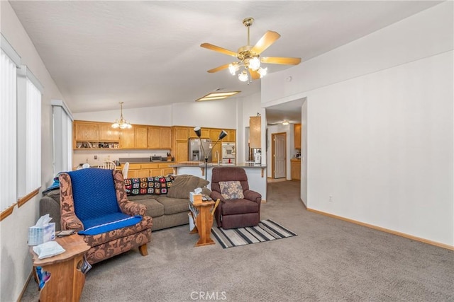 living room with lofted ceiling, light carpet, baseboards, and ceiling fan with notable chandelier